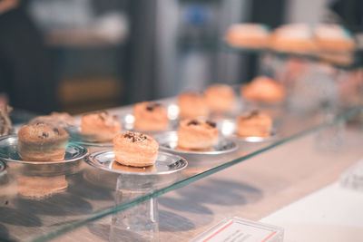 Food in plates on display cabinet at store for sale