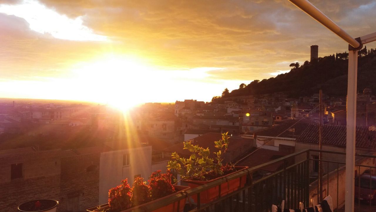 TOWN AGAINST SKY AT SUNSET