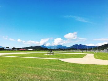 Scenic view of golf course against sky