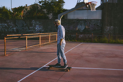 Man skateboarding at park during sunset