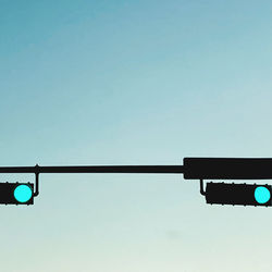 Low angle view of road against clear blue sky