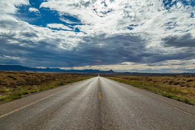 Road amidst landscape against sky