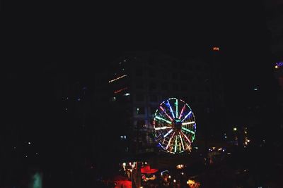 Low angle view of illuminated ferris wheel