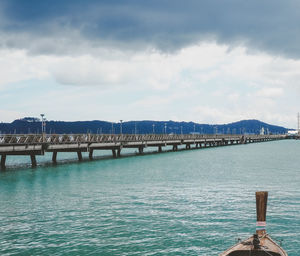 Pier over lake against sky