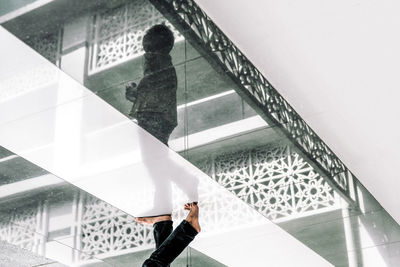 Low section of woman standing on stairs