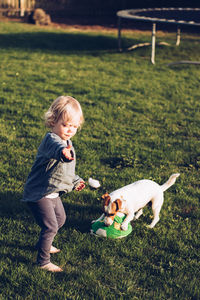 Cute girl playing with dog at park