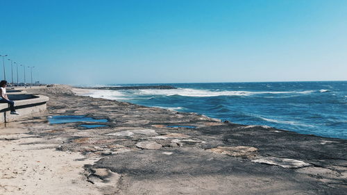 Scenic view of calm sea against clear sky