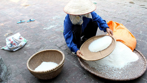 High angle view of man and woman sitting on street