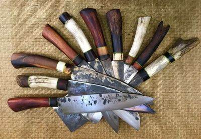 Directly above shot of shot of knives on jute