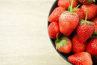 High angle view of strawberries in bowl on table
