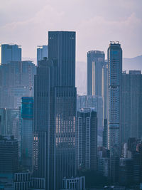 Modern buildings in city against sky