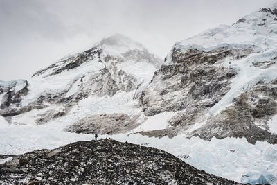 Snow covered mountains under overcast sky