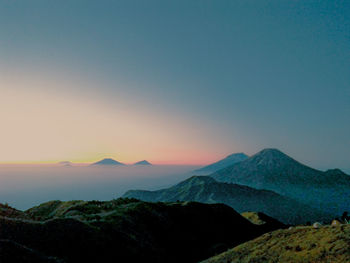 Scenic view of mountains against clear sky during sunset