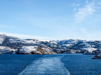 Scenic view of frozen sea against blue sky