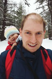 Portrait of smiling boy standing in snow