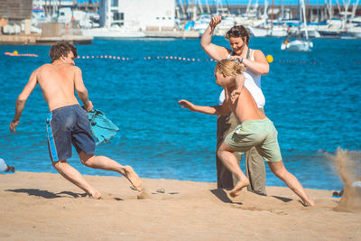 Full length of people enjoying on beach