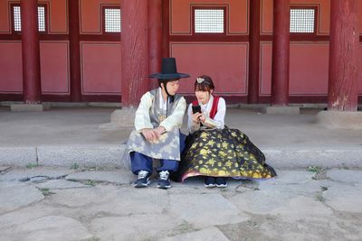 Young couple sitting outdoors