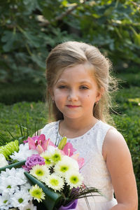 Portrait of smiling girl with pink flower