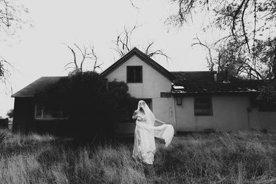 Rear view of woman standing on field