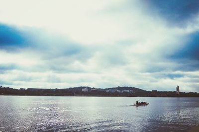 Scenic view of lake against cloudy sky