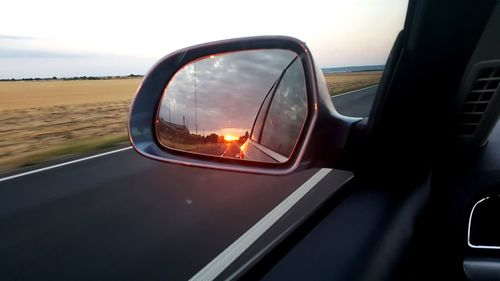 Reflection of car on side-view mirror