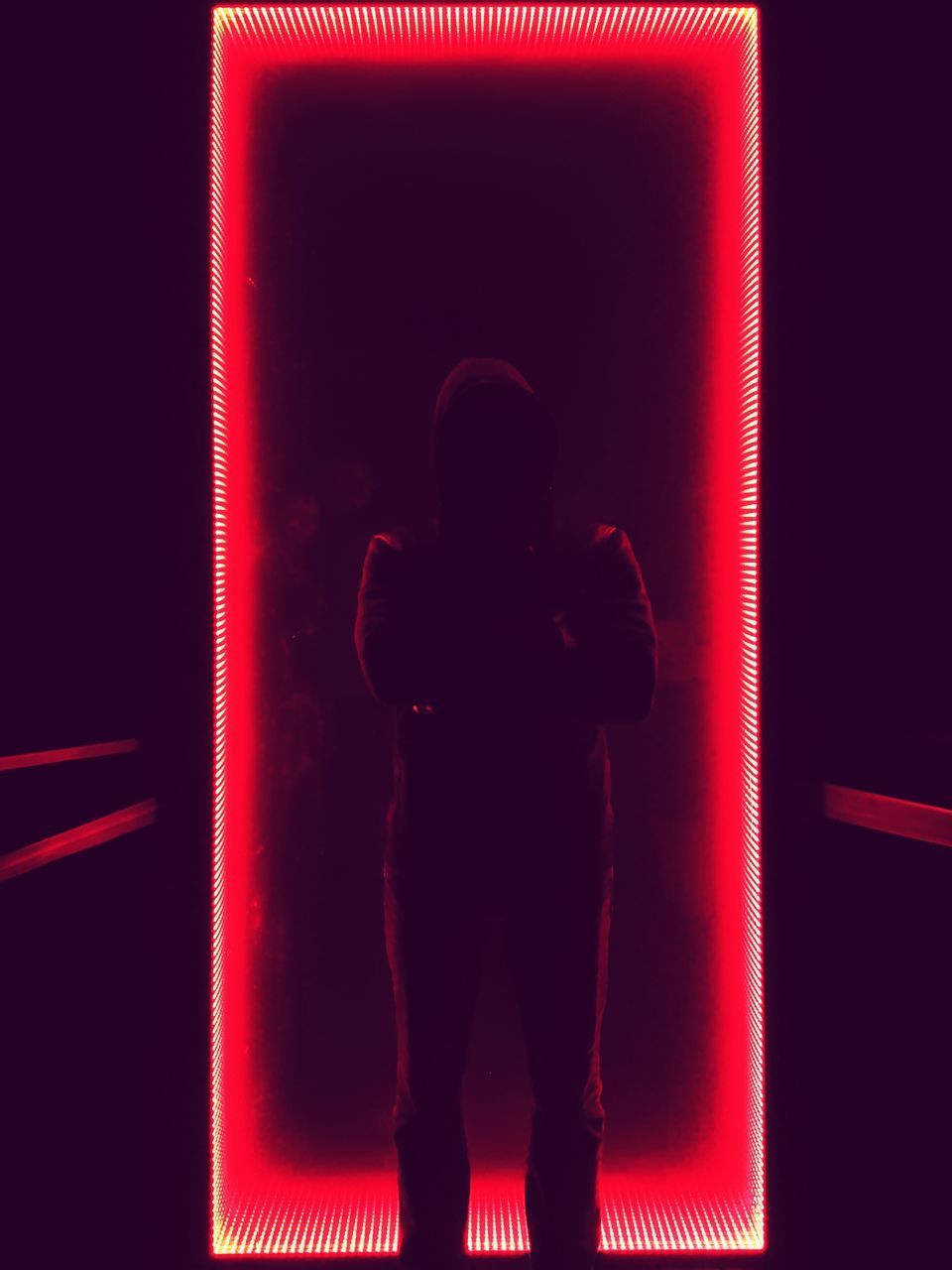 FULL LENGTH PORTRAIT OF SILHOUETTE MAN STANDING IN ILLUMINATED RED LIGHT