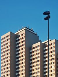 Low angle view of buildings against blue sky