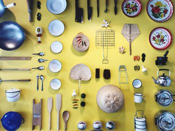 Flat lay of kitchen utensils on yellow background