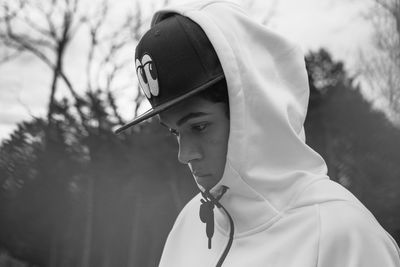 Teenage boy wearing hood looking down