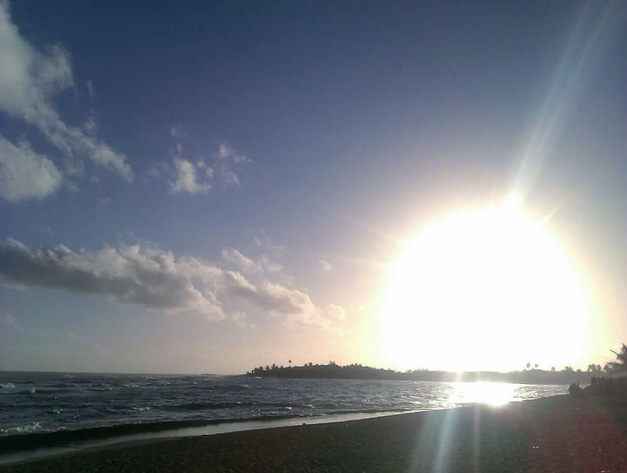 sea, water, beach, sun, horizon over water, scenics, tranquil scene, sunlight, sunbeam, beauty in nature, tranquility, sky, shore, sunset, idyllic, nature, vacations, lens flare, calm, majestic, sunny, wave, seascape, summer, coastline, cloud, ocean, bright, tide, coastal feature, day, tourism, non-urban scene, outdoors