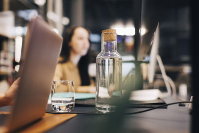 Water bottle and glass on desk at office