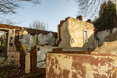 Old abandoned building against sky