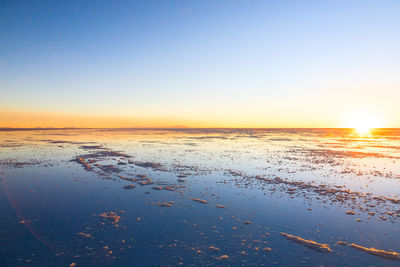 Scenic view of sea against clear sky during sunset