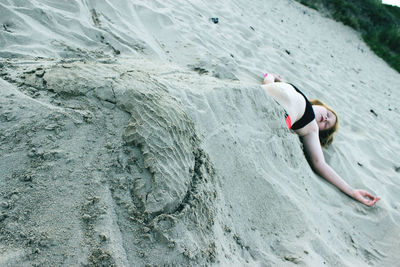 Girl buried in sand