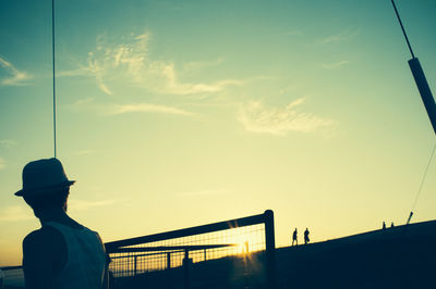 Silhouette of woman against sky during sunset