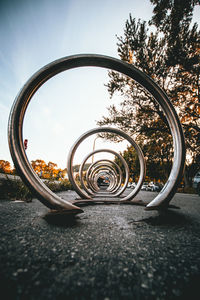 Close-up of bicycle on street against sky