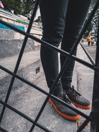 Low section of man standing on street