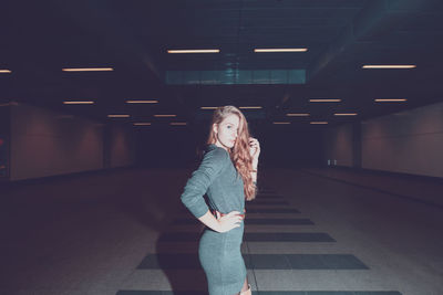 Young woman standing in underground walkway