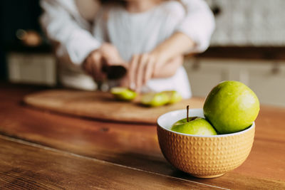 Happy mom and little daughter cooking together in the kitchen