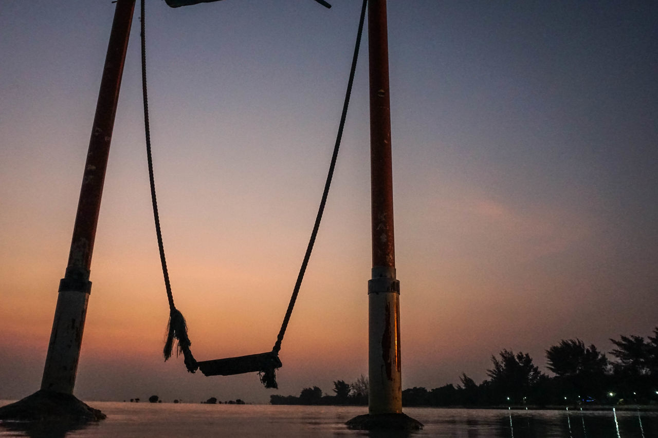 LOW ANGLE VIEW OF SILHOUETTE CRANES AGAINST SKY