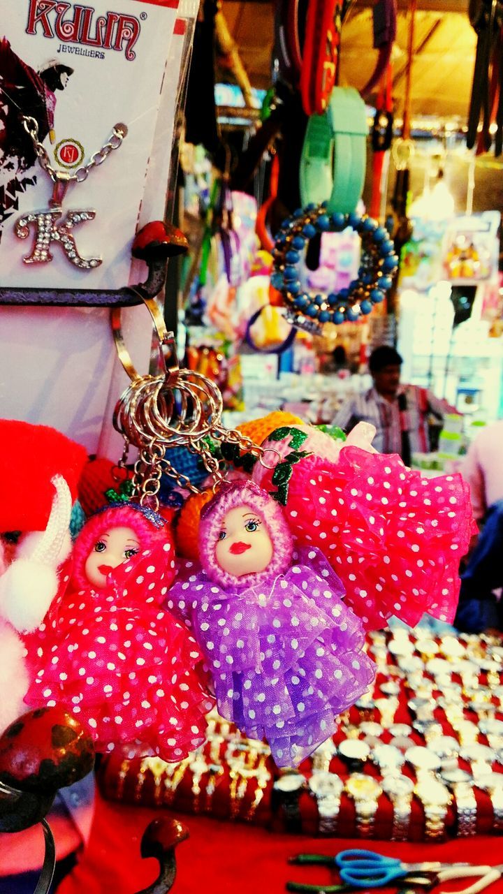 indoors, still life, variation, large group of objects, decoration, multi colored, table, choice, christmas, art and craft, high angle view, close-up, for sale, hanging, abundance, red, retail, no people, tradition, celebration