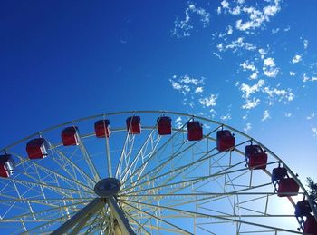 Ferris wheel against blue sky in park