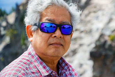 Close-up portrait of man wearing sunglasses