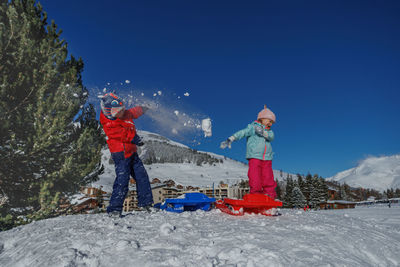 Low angle view of man standing on snow