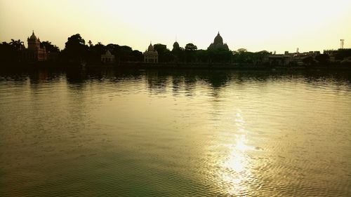 Scenic view of lake against sky at sunset