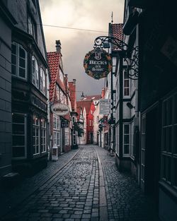 Street amidst buildings in city against sky