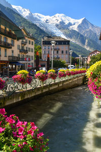 Bridge over river amidst mountains against sky