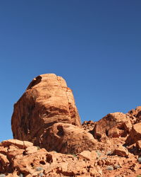 Rock formation against clear blue sky