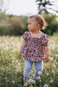 Portrait of boy standing on field