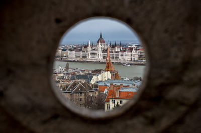 View of buildings seen through hole in city
